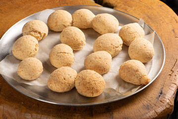Cheese bread, shape with cheese bread arranged on rustic wood, dark background, selective focus.