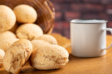 Cheese bread, basket with cheese bread arranged on rustic wood, dark background, selective focus.
