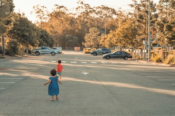 Closeup view of children running in a car parking area