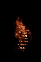 Vertical shot of a bonfire outdoors at night - perfect for wallpapers