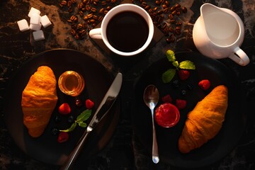 Top view of a black coffee on the table with two plates of croissants with jam - Powered by Adobe