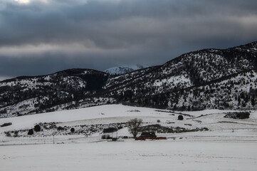 Fototapeta na wymiar Snowy mountain range on a gloomy day