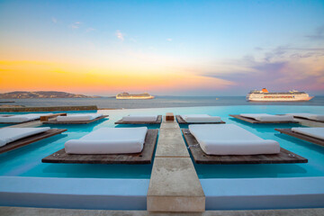 Infinity pool with cruise at sunrise, Mykonos, Greece