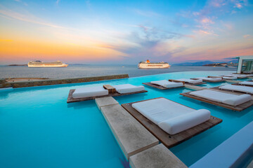 Infinity pool with cruise at sunrise, Mykonos, Greece