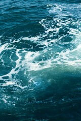 Vertical shot of a bright blue sea surface