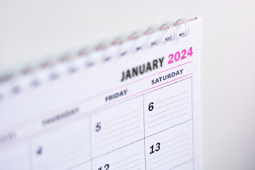 Close up of blank 2024 calendar hanging on fridge with the words January 2024. New year concept,...