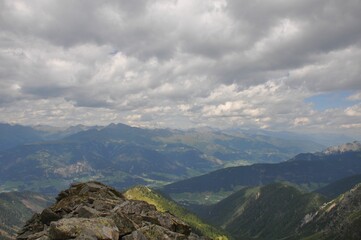 Beautiful landscape of big mountains of the Alps in Italy under the cloudy sky during the daytime