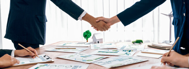 Business people hand shake in Eco corporate meeting room after made successful agreement deal on...