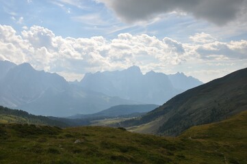 Beautiful landscape of big mountains of the Alps in Italy under the cloudy sky during the daytime