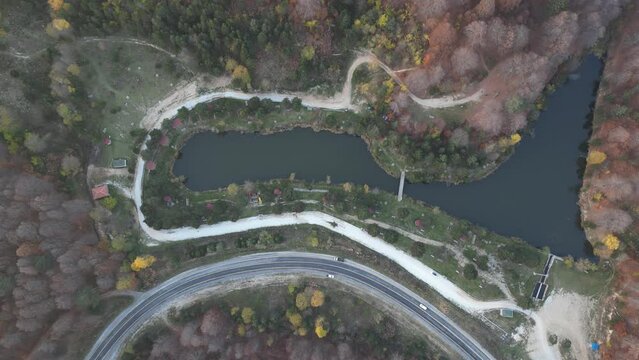 Curvy mountain roads in autumn. Vehicles in motion on winding mountain roads. 