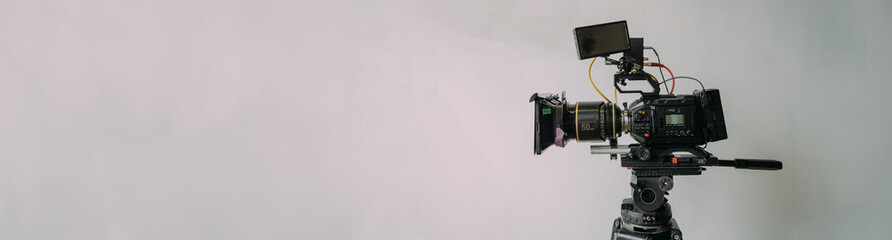 Professional cinema and video camera on the set. Shooting shift, lighting fixtures, shooting equipment and the team.