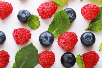 Raspberry and blueberrys on white background. Food background.