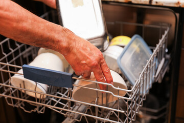 hand-washing dishes, symbolizing equality and shared responsibilities of men and women gender roles...