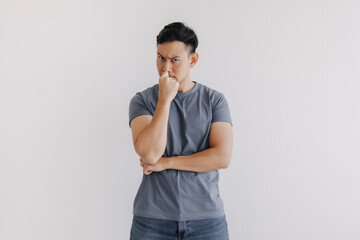 Serious and doubt face of man thinking of something stand isolated on white.