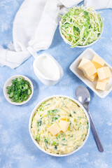 Traditional Irish dish Colcannon or mashed potato with green cabbage and butter, vertical top view