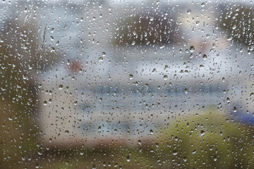 Rain drops on window glass close up abstract background texture