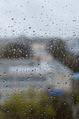 Rain drops on window glass close up abstract background texture