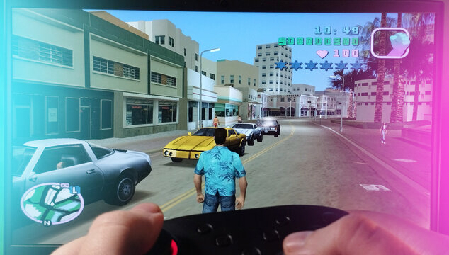 A guy plays GTA: Vice City with a gamepad. Photo of the Rockstar game. Stock editorial photo. Kyiv. Ukraine. 10.11.2023.