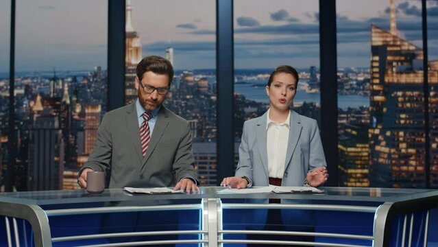 Couple hosts reporting news in multimedia channel closeup. Reporters discussing