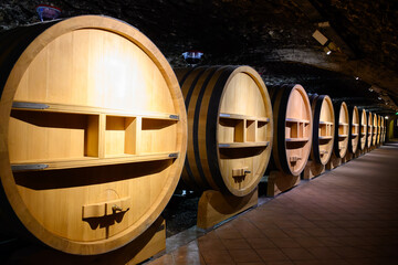 Underground wine cellars with barrels for aging of red dry wine in Chateauneuf-du-Pape wine making...