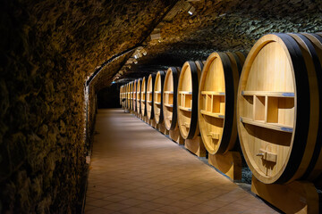 Underground wine cellars with barrels for aging of red dry wine in Chateauneuf-du-Pape wine making...