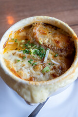 French cuisine, onion soup with melted gruyere cheese and slices of baguette served hot from oven