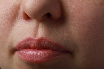 Closeup view of woman with normal skin and beautiful lips