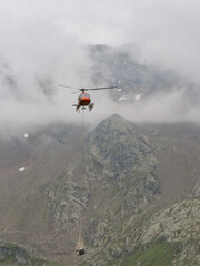 Fototapeta na wymiar helicopter at a supply flight for an alpine refuge hut in the Stubai alps, South Tyrol, Italy