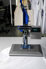 Printing logo. Heat press with t-shirt on white table, space for text