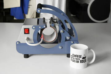 Printing logo. Heat press and cup on white table