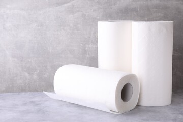 Rolls of paper towels on grey table
