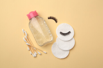 Flat lay composition with makeup remover and false eyelashes on yellow background