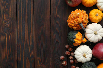Thanksgiving day. Flat lay composition with pumpkins on wooden table, space for text