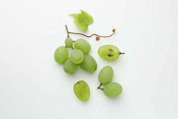 Fresh grapes and leaf on white background, top view