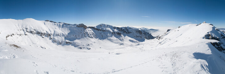 Fototapeta na wymiar Snowy peaks glisten against a vast blue canopy