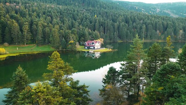 Wooden lake house on the water in the forest. View of Abant-Golcuk Lake. The harmony of blue and green. Magnificent lake view. Golcuk National Park Bolu, Turkey.