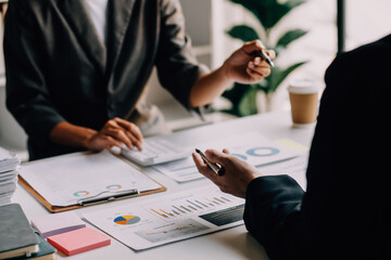 Businesswoman or accountant working Financial investment on calculator, calculate, analyze business and marketing growth on financial document data graph, Accounting, Economic, commercial concept.