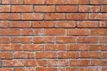 Red brick wall background in rural room. Abstract weathered texture stained old stucco light Red. Red grunge brick wall background.