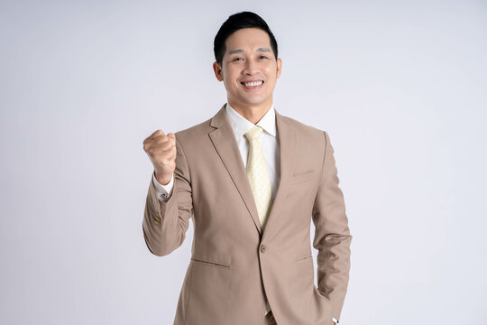 Image of Asian male businessman posing on white background