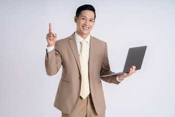 Image of Asian male businessman using laptop on white background