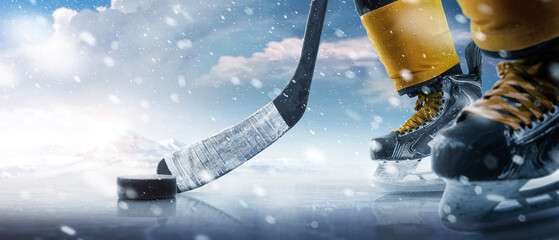 Hockey puck and stick close-up. Hockey player in ice rink. Focus on the puck. Hockey concept. Ice....