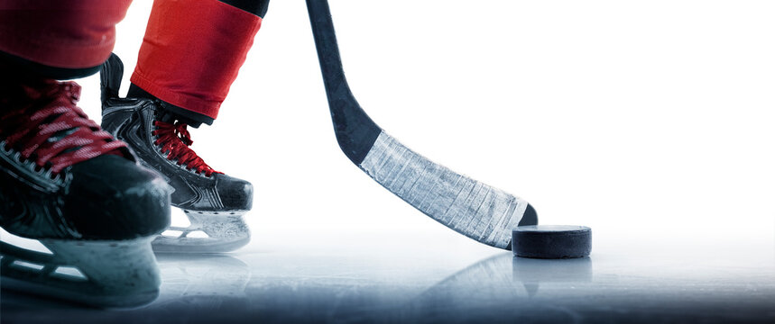 Hockey puck and stick close-up. Hockey player in ice rink. Focus on the puck. Hockey concept. Ice. Isolated