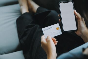 Beautiful woman sitting on a outdoors and using at laptop. Woman and friend having fun with new technology and shopping online at outdoor place.