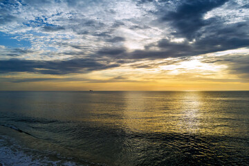 Early sunrise over ocean waves in morning