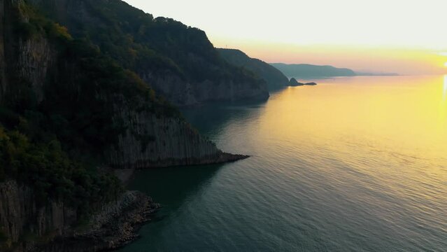 Guzelcehisar is famous for its lava basalt columns. The columns were viewed with a drone at sunset. Lava landscape and the Black Sea. Amasra, Bartin, Turkey.