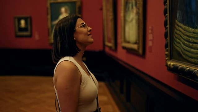 Young beautiful hispanic woman visiting art gallery at Art Museum in Vienna