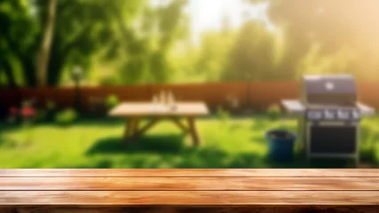 Fotobehang Empty wooden table and blurred bbq in the garden background, for product display montage. High quality photo © oksa_studio