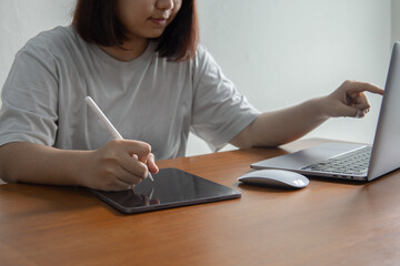 University student study and work in the school library.She using laptop and learning online,...