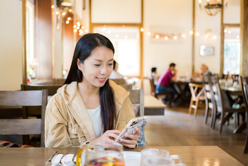 Woman use of mobile phone in restaurant