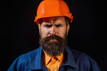 Portrait worker in construction helmet. Builder foreman or repairman in builder uniform. Worker in studio. Construction manager, builder in helmet. Male builder engineer.